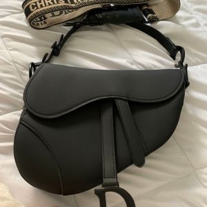 Dior black ultramatte saddle bag.
